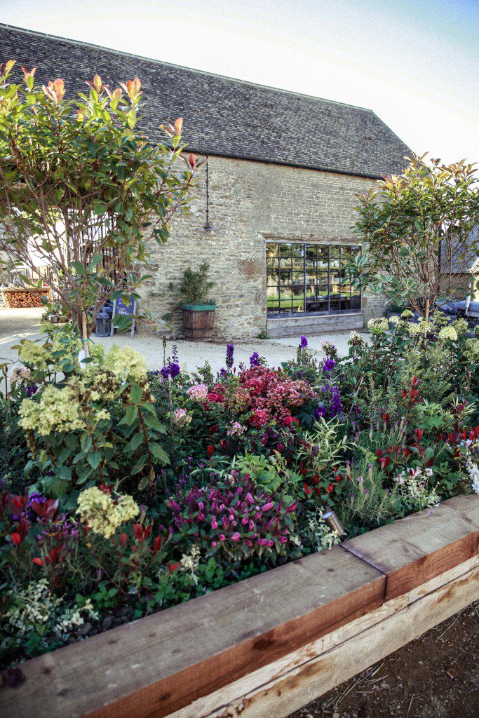 Soho Farmhouse wedding photography . Beautiful flowers at the entrance