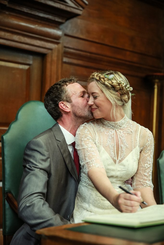 There are various moments throughout your typical wedding day that can be quite repetitive and boring. Signing the register is one of them. I love this shot because she spontaneously sat on her new husband's lap and it made the shot that much more interesting and fun.