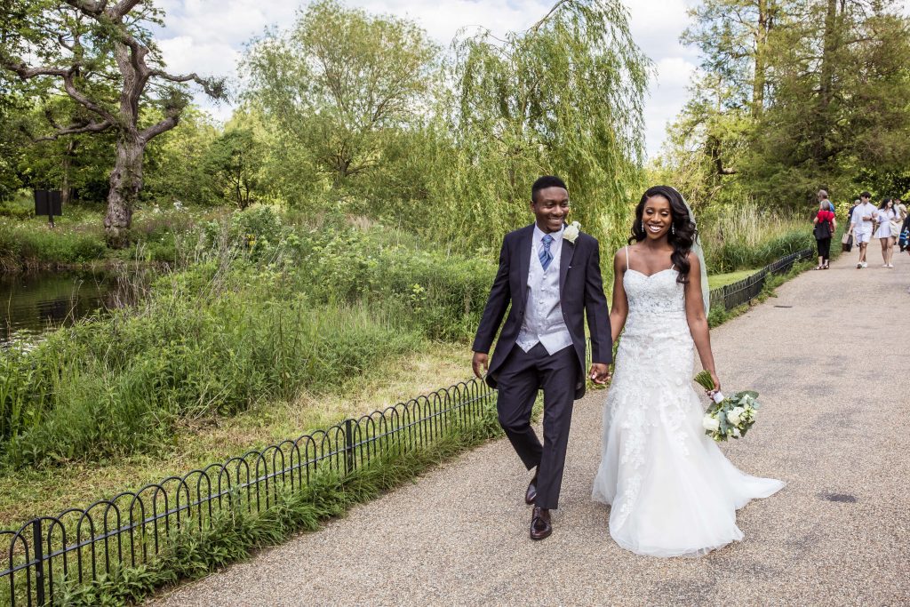 bride and groom walk in regents park, london wedding photographer