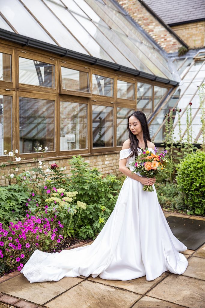 Bride and flowers. Hanbury Manor wedding photographer, photography
