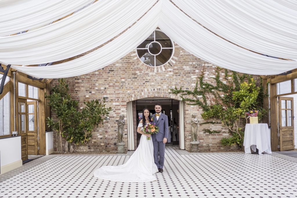bride and groom in gardens Hanbury Manor , wedding photography