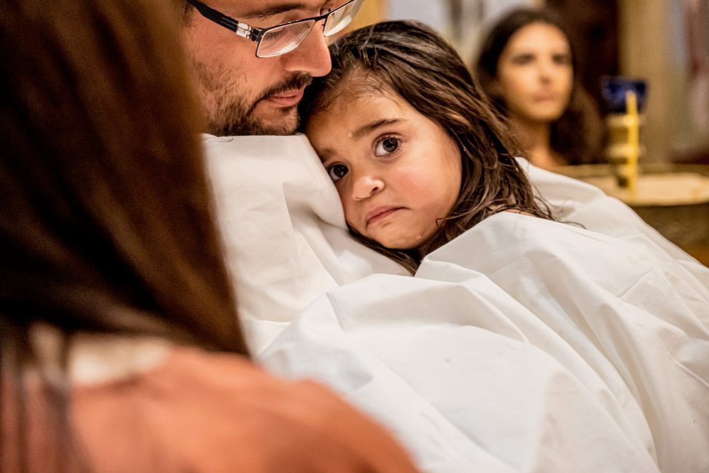 tearful little girl christening greek church