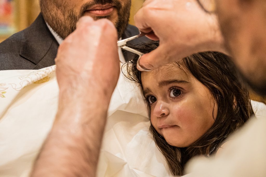 little girl hair being cut greek christening