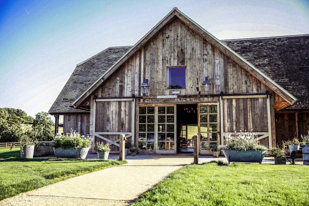 the barn at a wedding at soho farmhouse , photography shows a sunny day