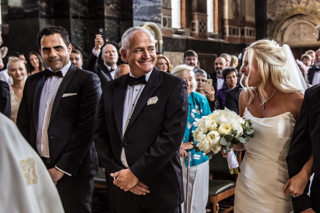 Groom looks at bride as she arrives at the alter, st sophia greek orthodox church Moscow Road