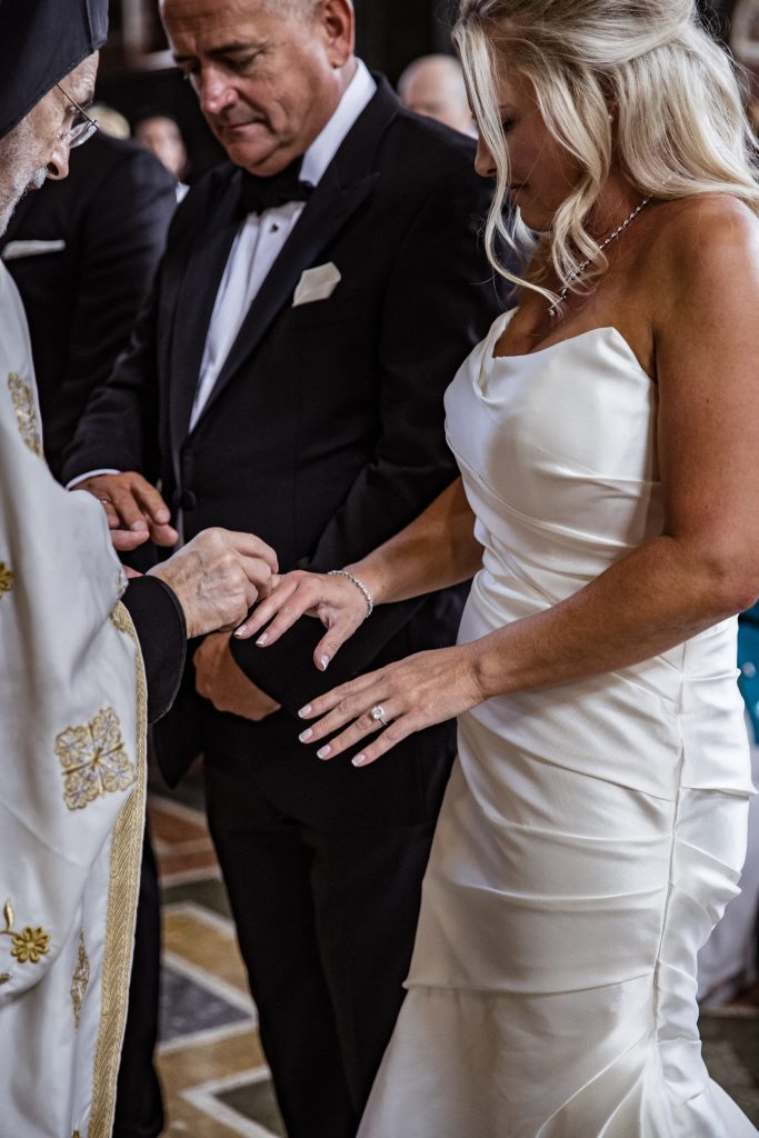 Greek priest places ring on brides finger, St Sophia greek orthodox church, Moscow Road, London