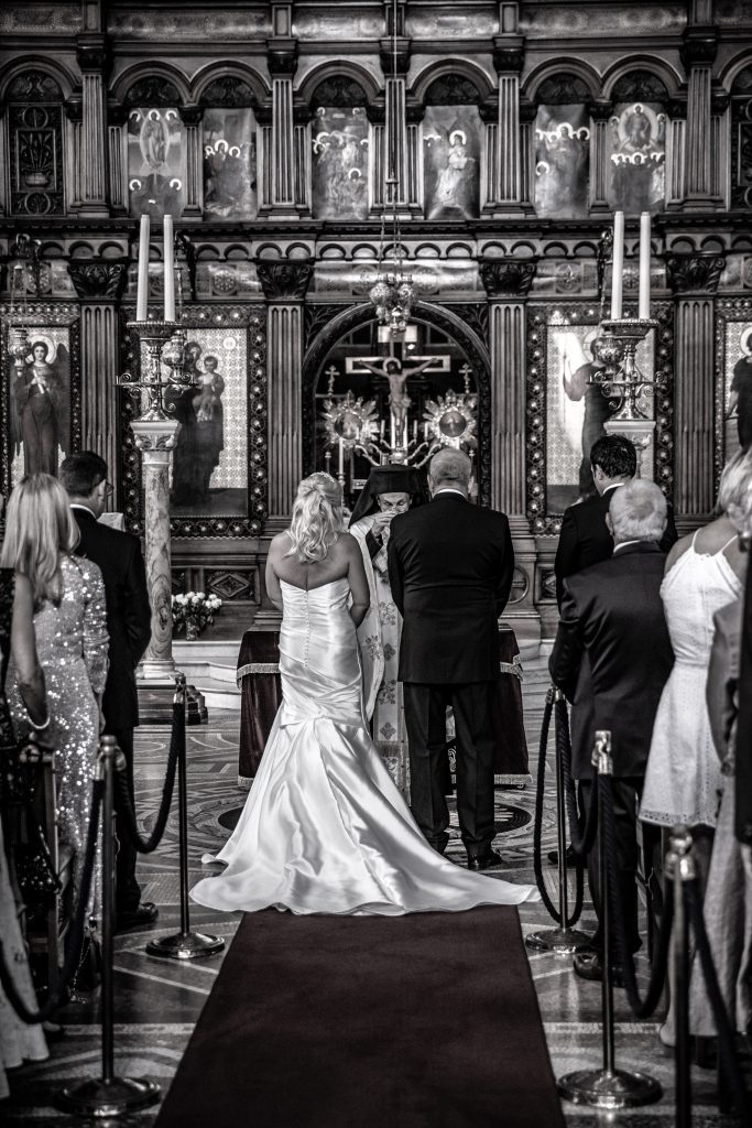 The bride and groom at their greek orthodox wedding at St Sophia greek orthodox church in Moscow Road, London