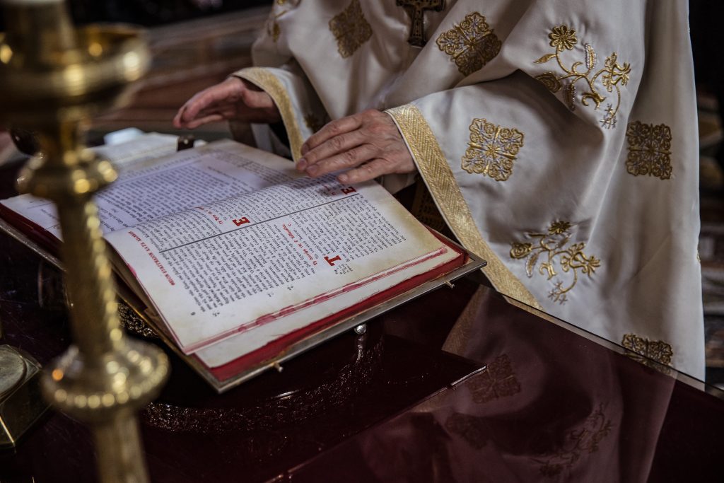 A greek orthodox priest reads from book, st Sophia greek orthodox church, Moscow Road