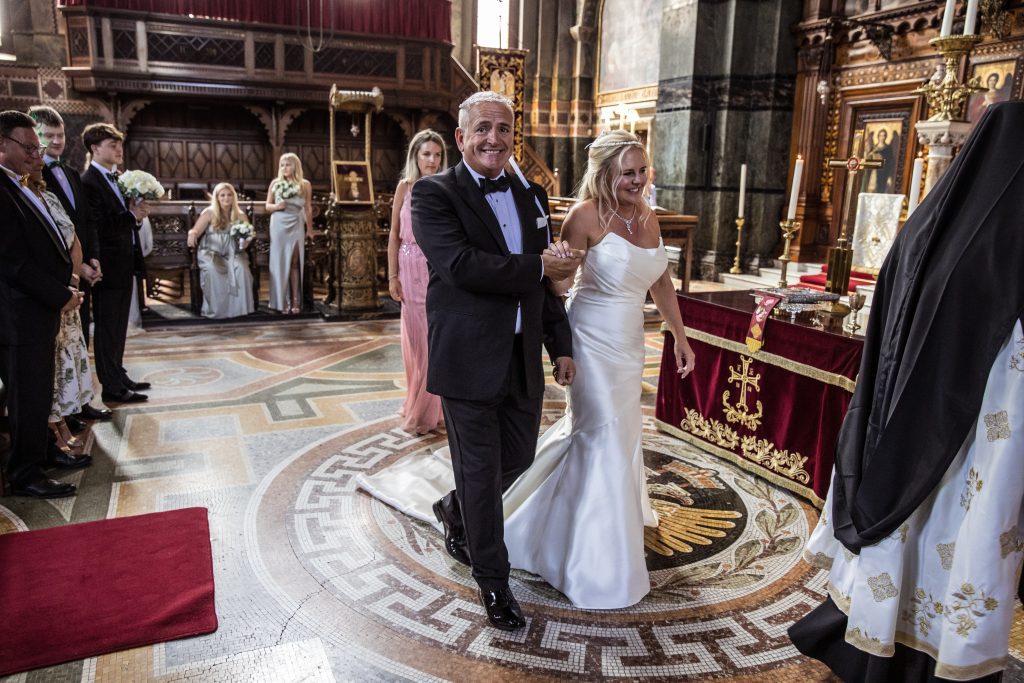 Bride and groom walks around the alter St Sophia Greek orthodox wedding, photographer Natalie martinez