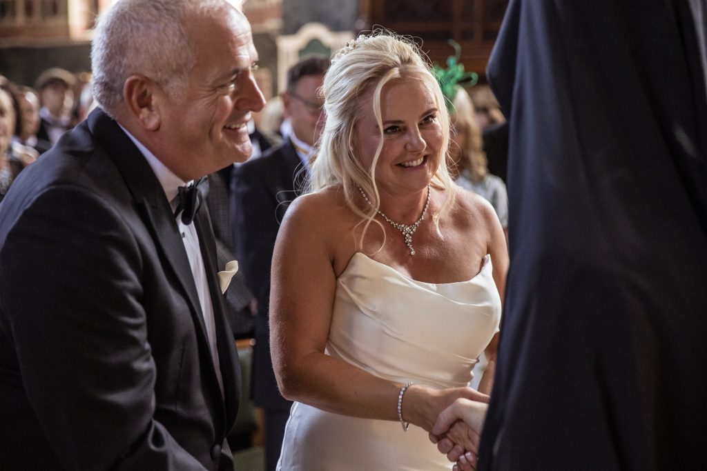 Bride thanks priest after greek ceremony, st sophia greek orthodox wedding, Moscow road