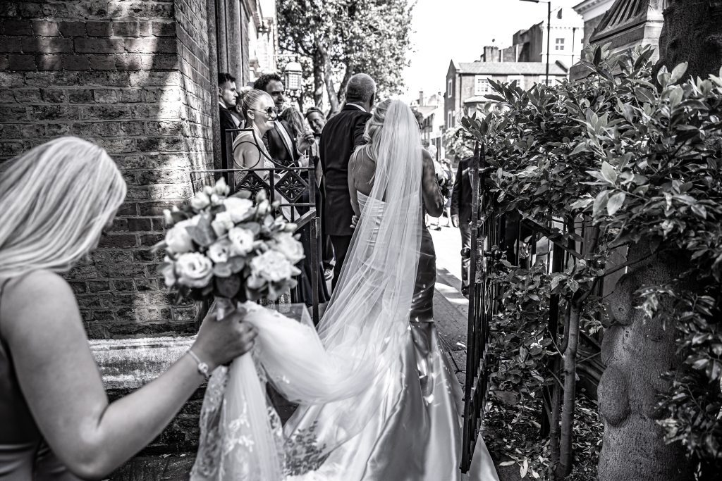 The bride outside St Sophia greek orthodox church after her wedding photography .