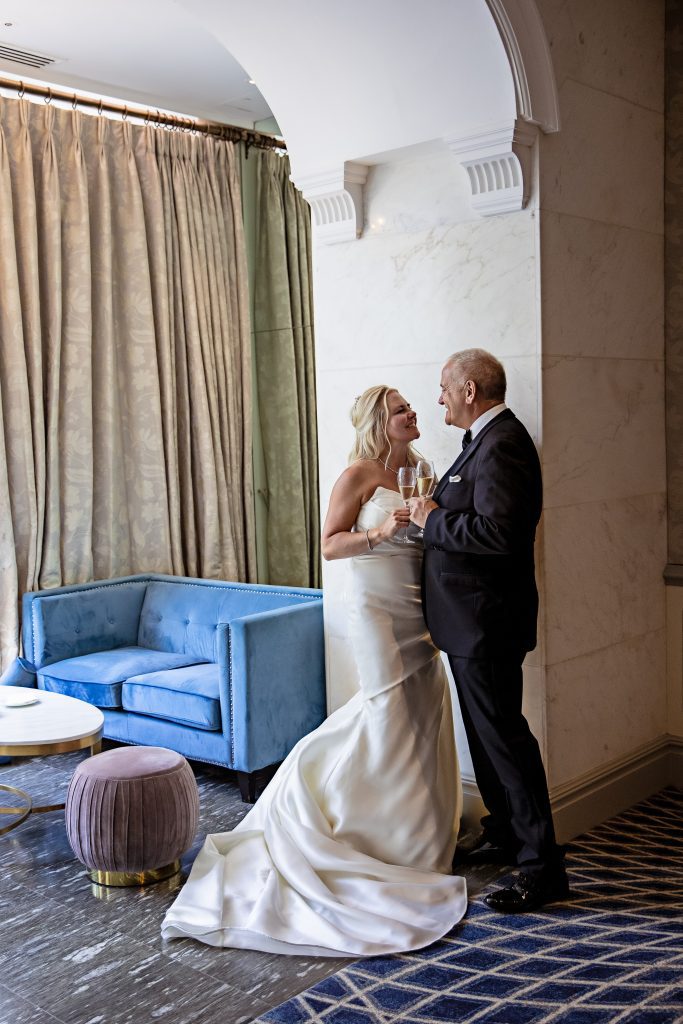 A bride and groom pose at their wedding at The savoy in London. Wedding photography