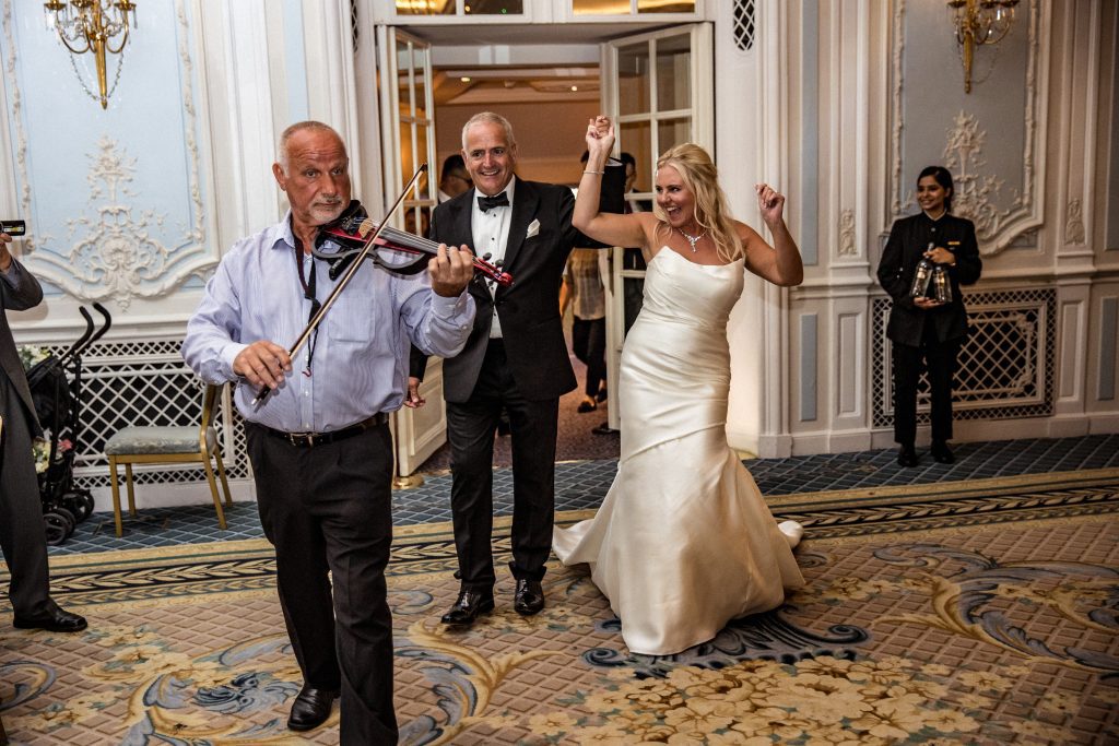 Bride and groom enter the room at their wedding at The Savoy in London.