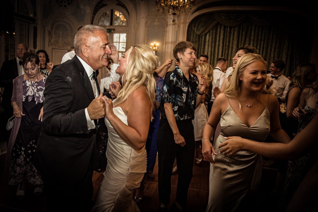 The bride and groom kiss on dancefloor at the Savoy hotel in London