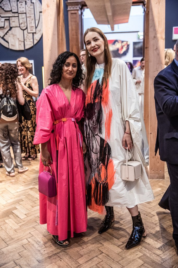 Guests pose at the Royal Academy summer party photographer