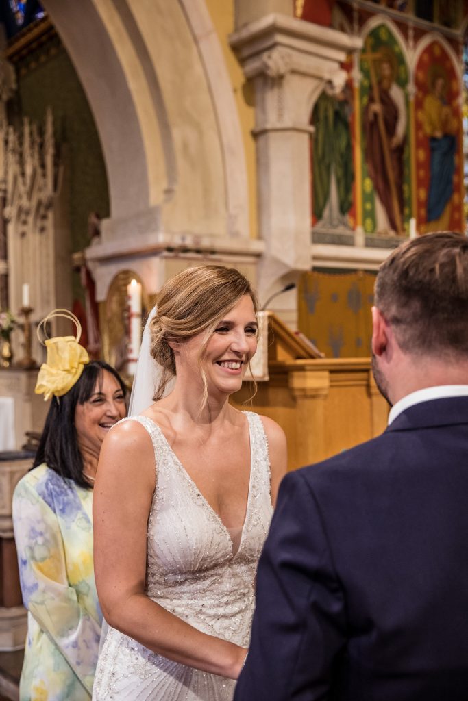 a bride laughs as she recites her vowels