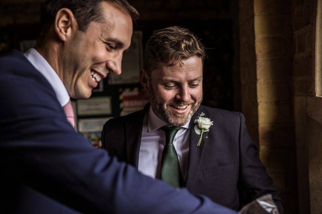 best man smiling at a wedding