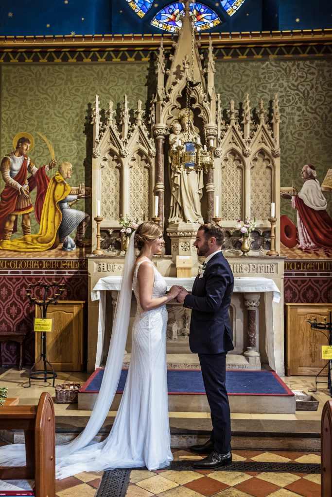 Hertford catholic church bride and groom pose
