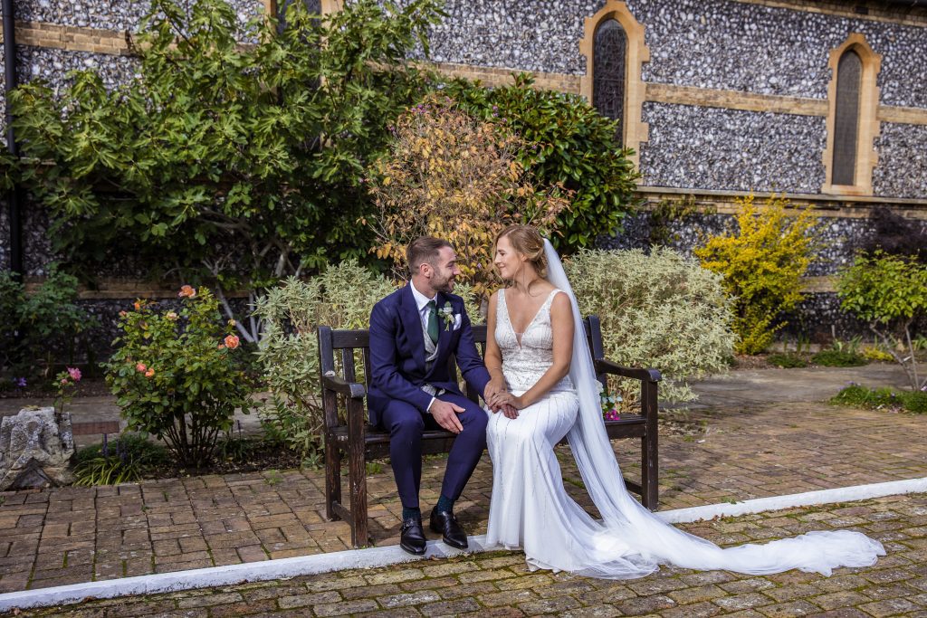 bride and groom outside hertford church gardens