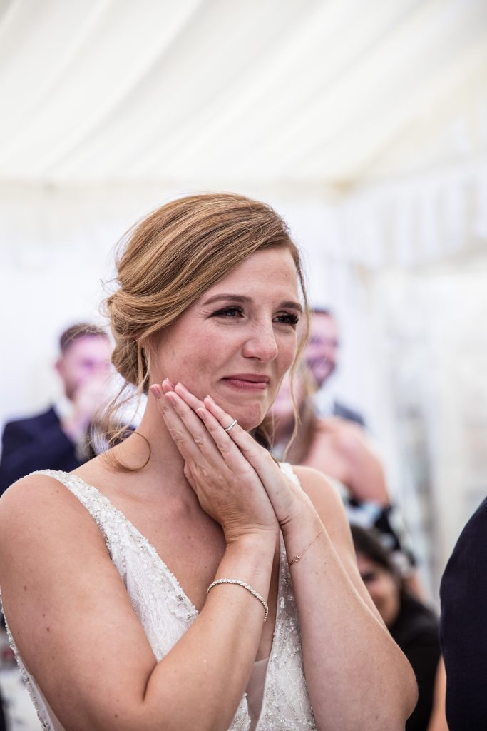 A bride cries as she listens to speech