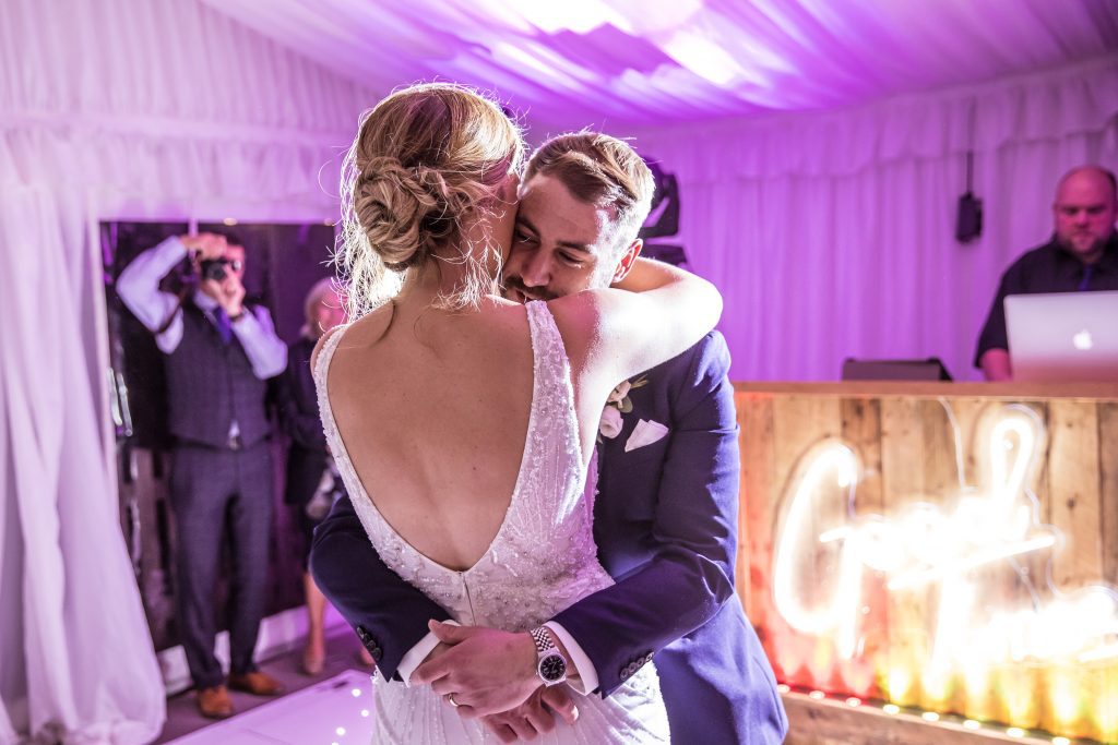 bride and groom embrace during first dance