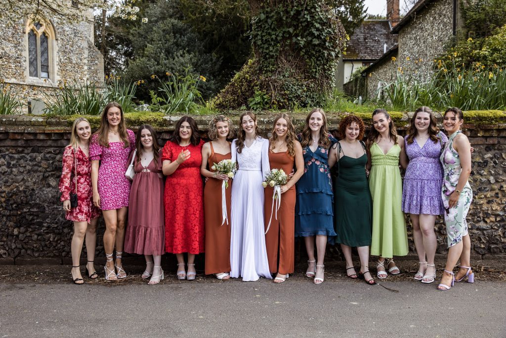 A bride lines up with her female wedding guests in Hertfordshire wedding photography