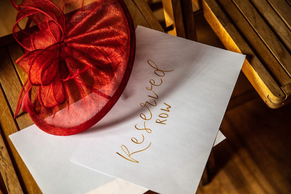 a reserved sign on a seat at a wedding ceremony