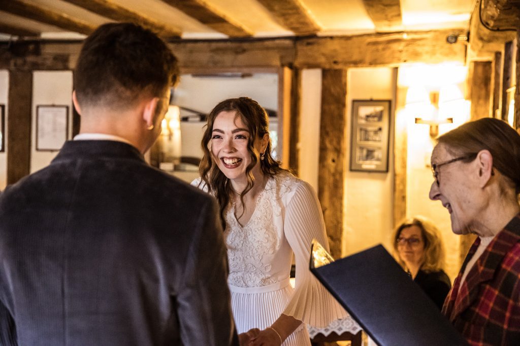 the bride laughs during her ceremony at The Barley Townhouse in Royston