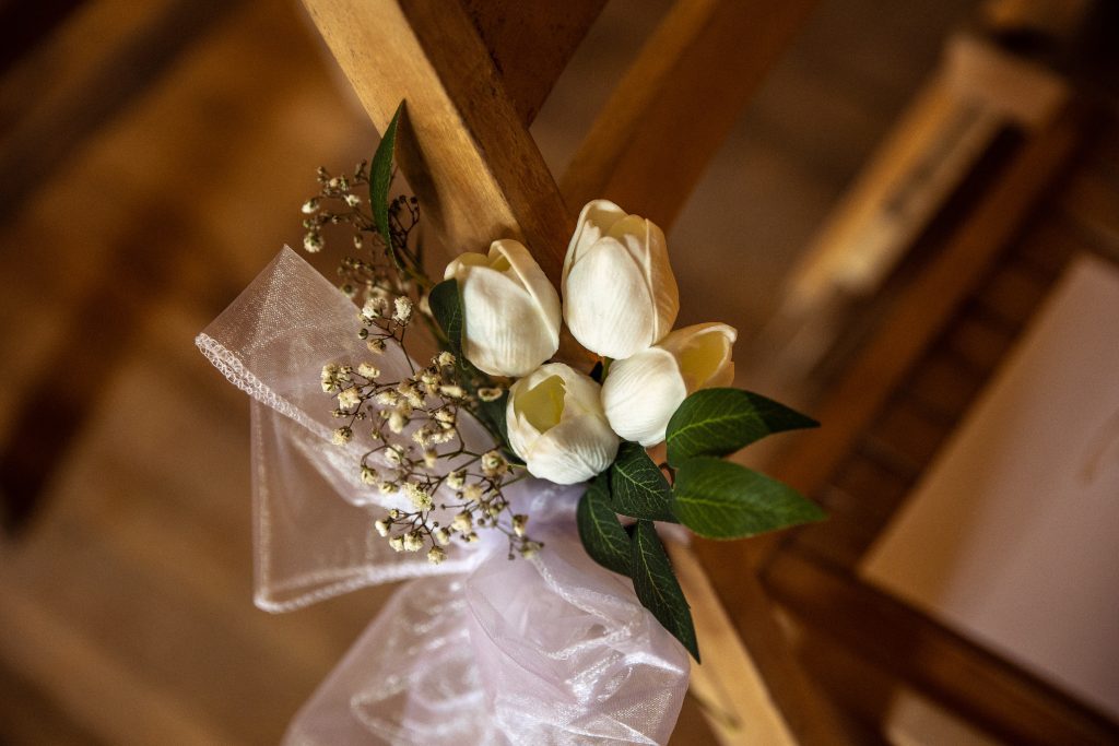 white tulips tied to a chair at a wedding ceremony at The Barley Townhouse