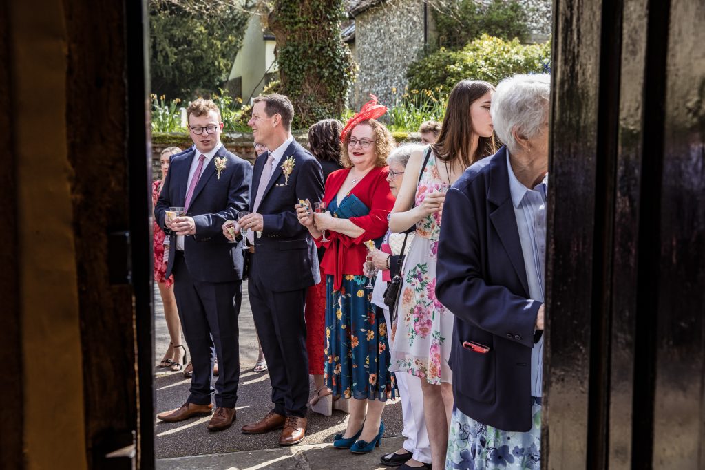 guests wait to throw confetti outside The Barley Townhouse in Royston