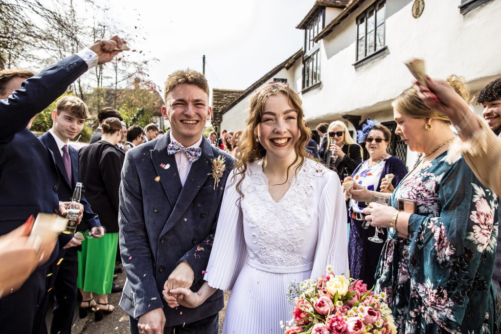 guests throw confetti outside The Barley Townhouse in Royston