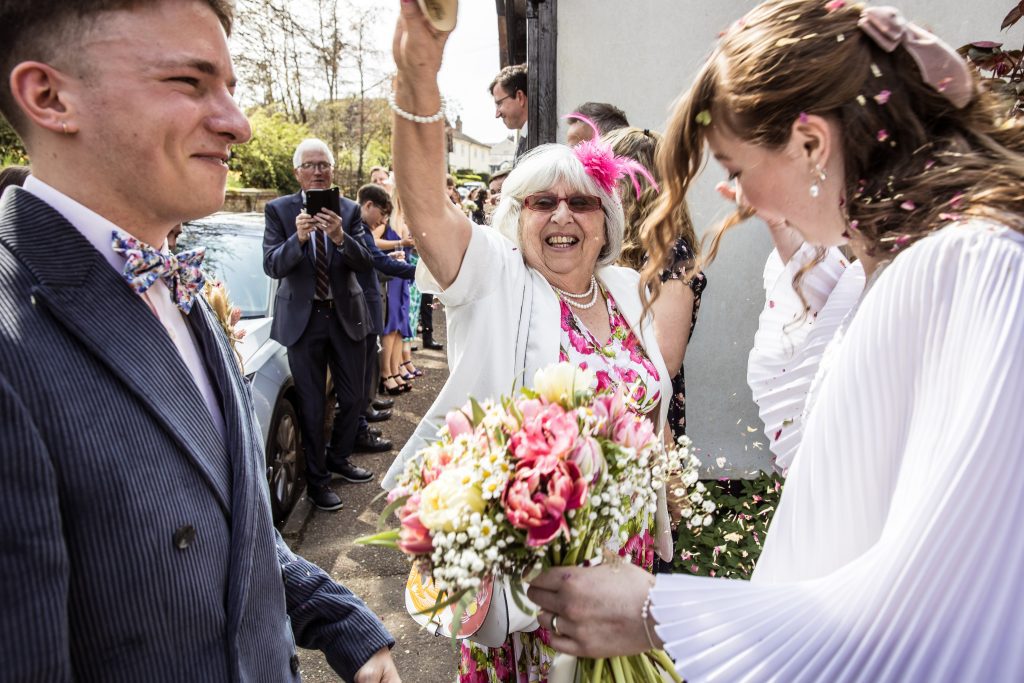 guests throw confetti outside The Barley Townhouse in Royston