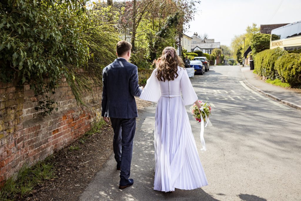 the bride and groom take a walk outside  The Barley Townhouse in Royston