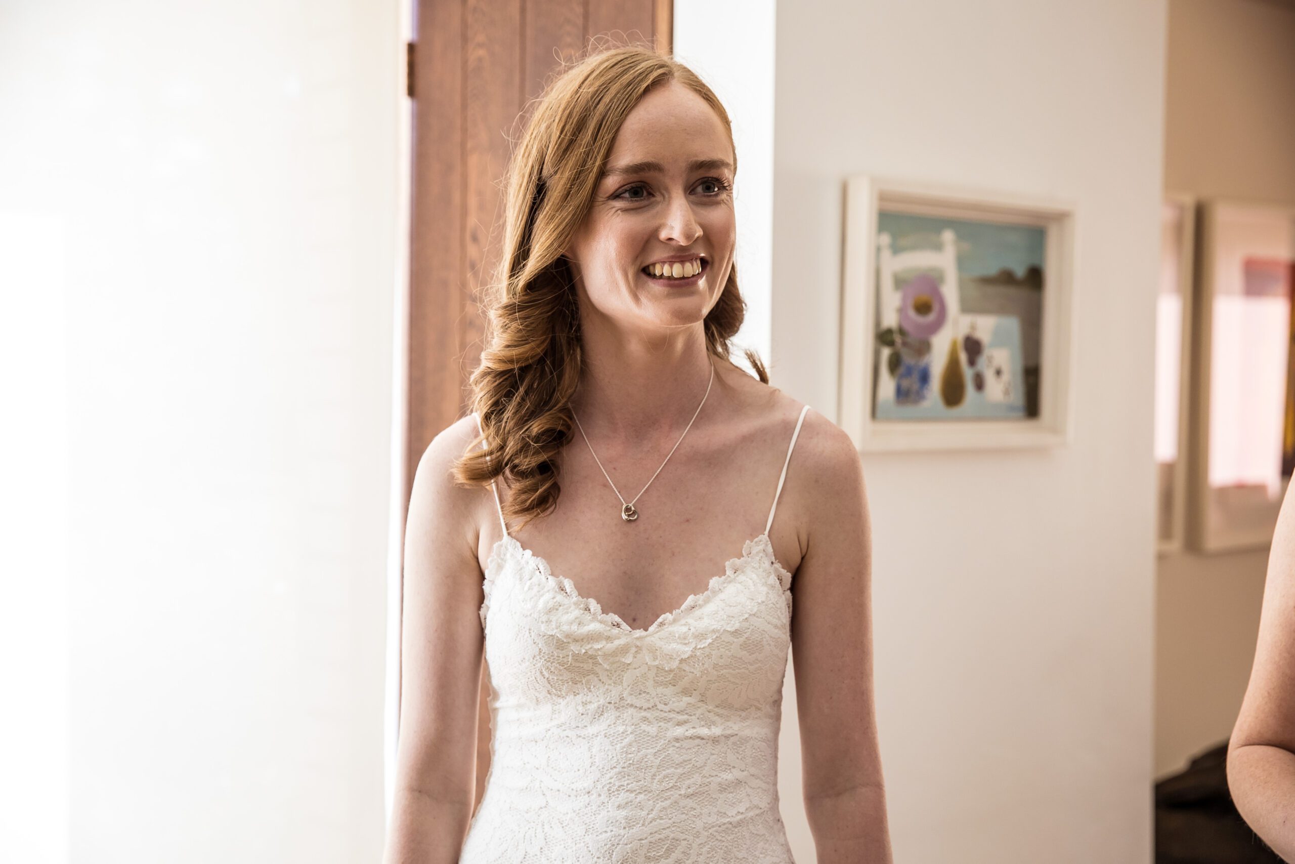 a redhead bride smiles at her father at her hertfordshire wedding
