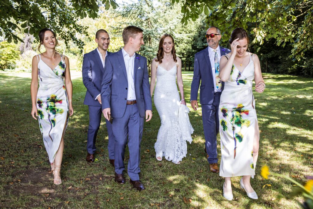 the bridal party walk through the garden to the wedding service