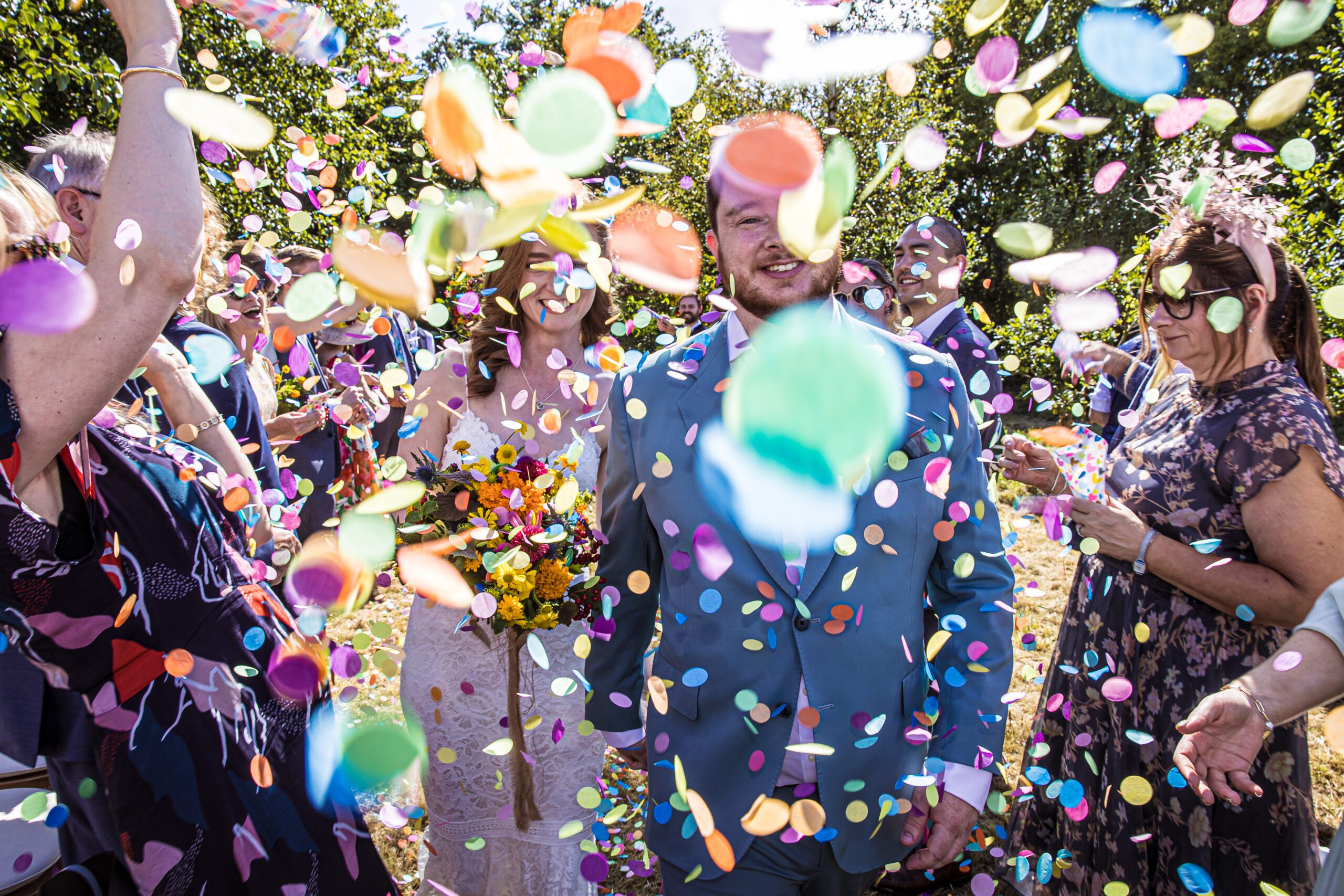 the bride and groom are surrounded by wedding confetti