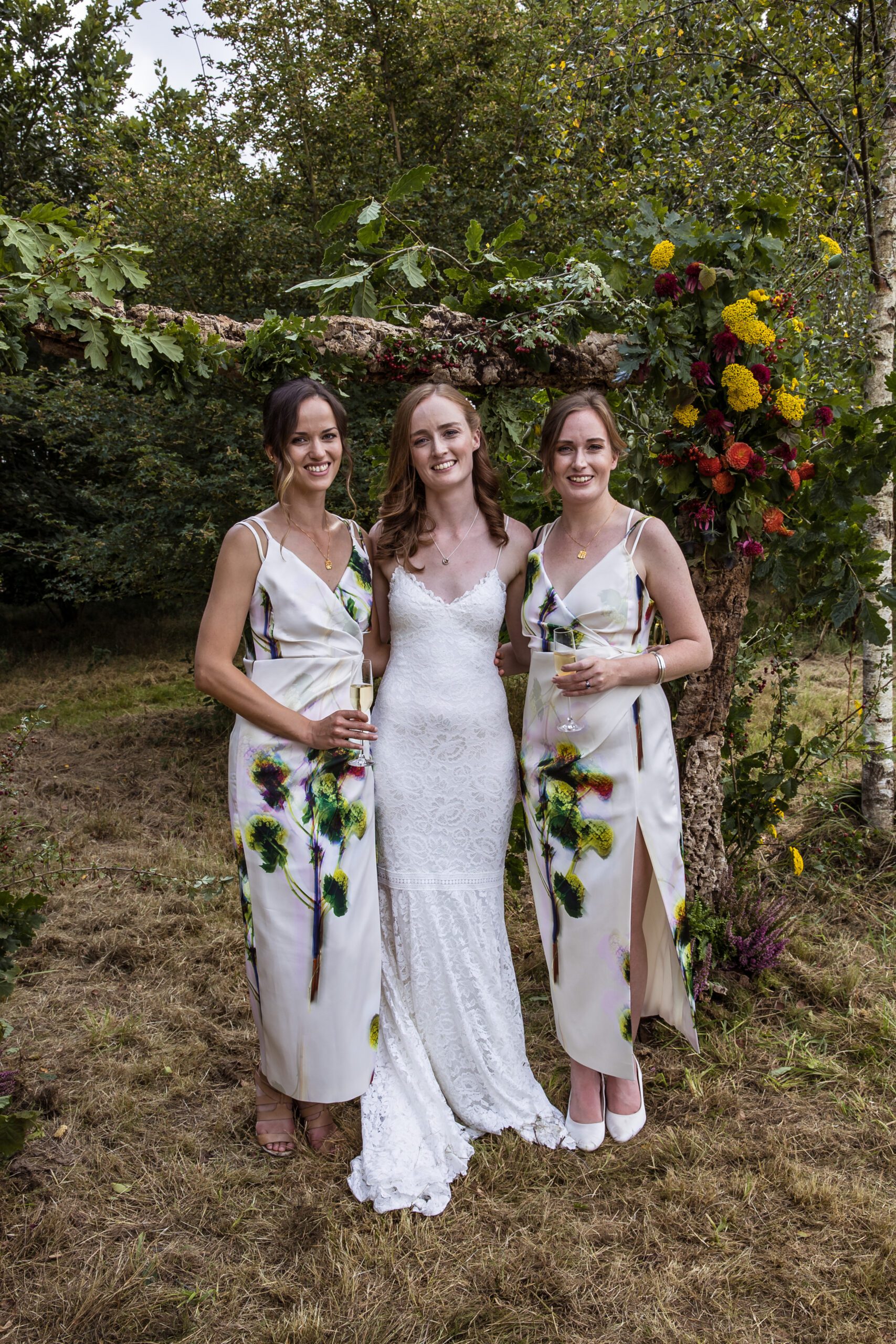 a bride poses with her bridesmaids at her hertfordshire wedding