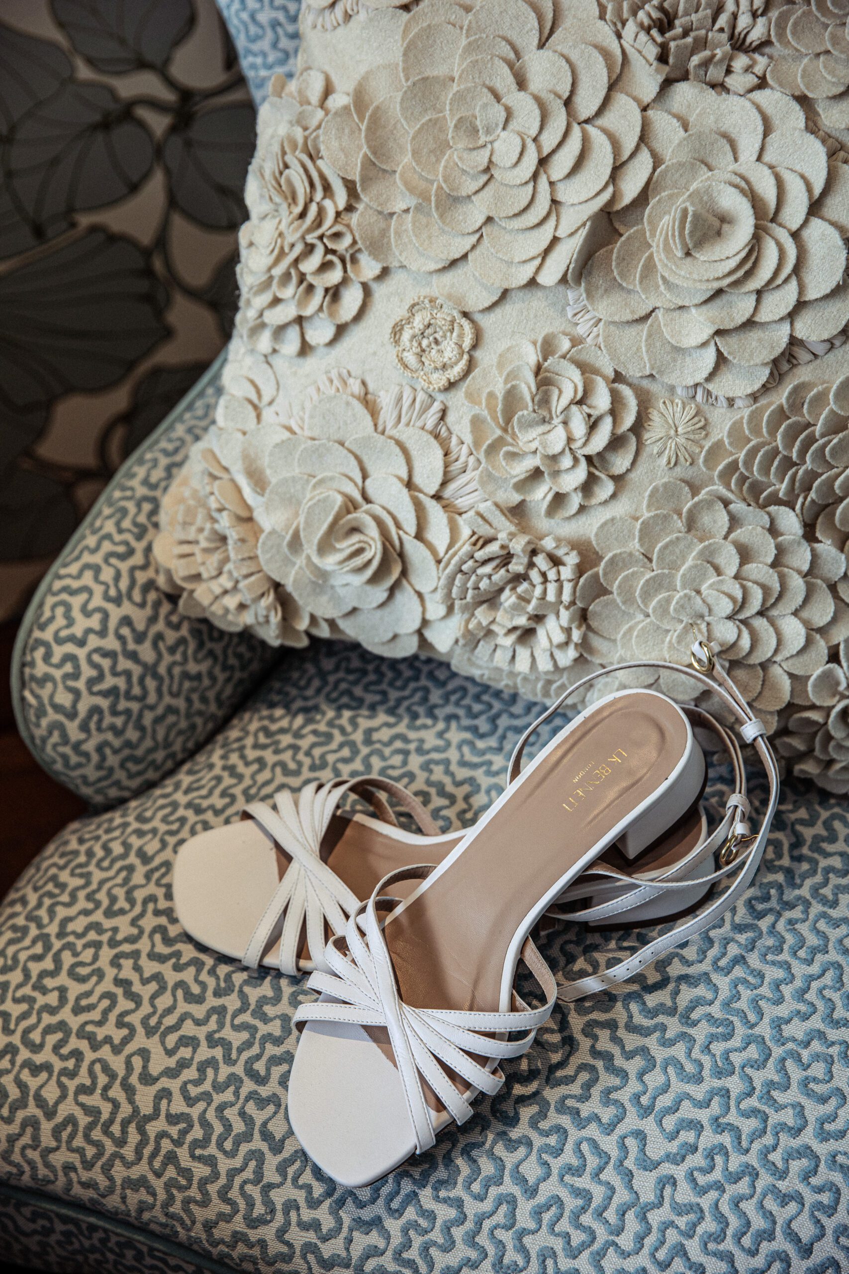 bridal shoes on a laura ashley style armchair at a wedding in hertfordshire