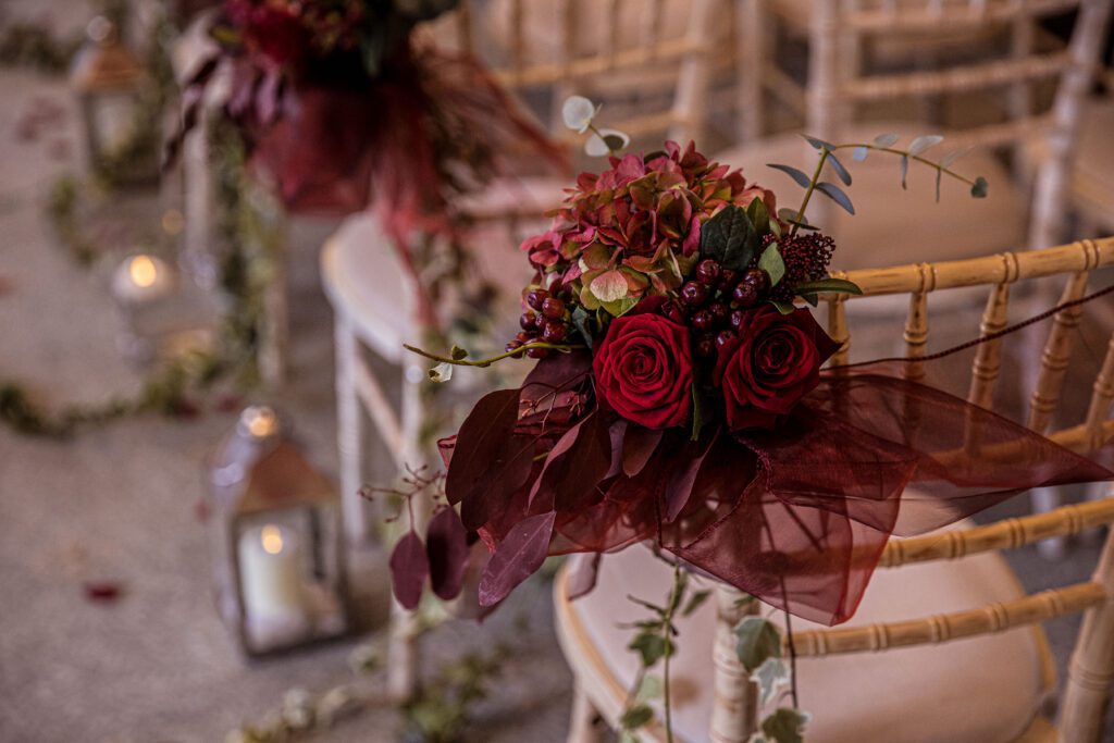 A flower decoration on a chair at a wedding at Fanhams Hall in Hertfordshire.