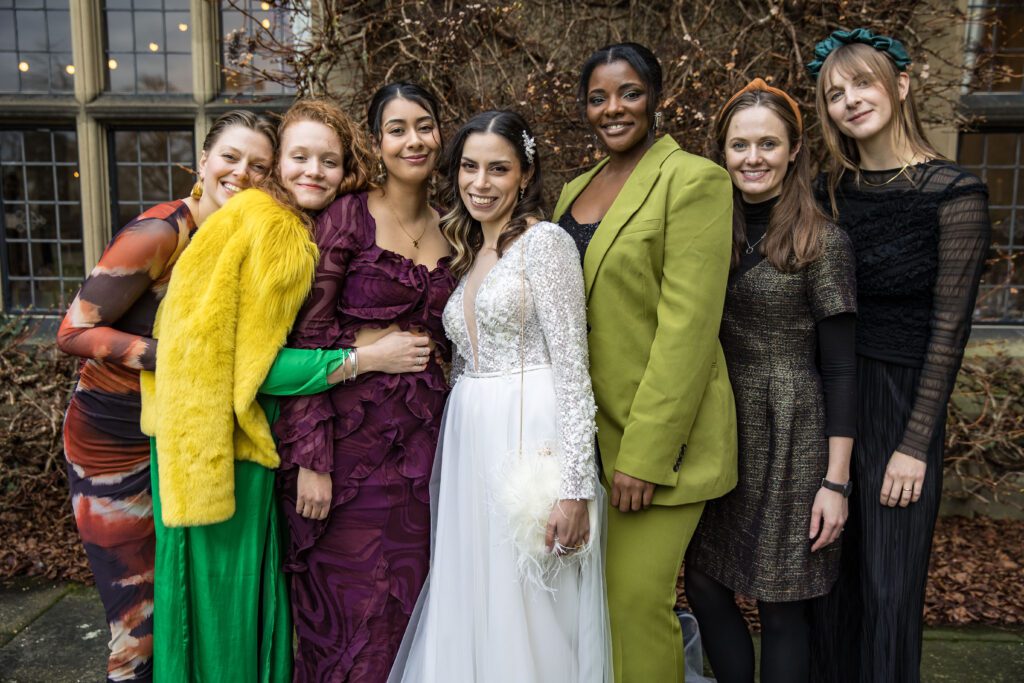 A bride and her best friends pose in the gardens of Fanhams Hall