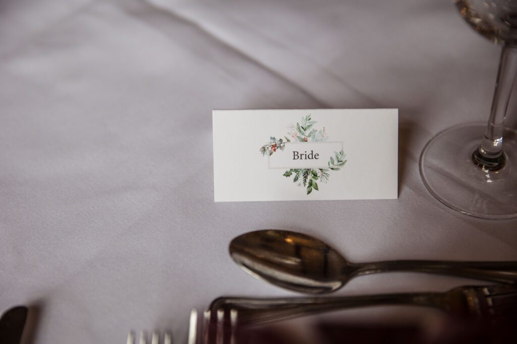 A table placing that reads 'Bride' on a table at fanhams Hall