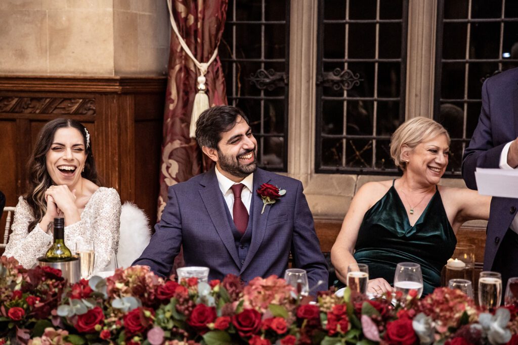 The brides brother smiles during the speeches at a wedding breakfast at Fanhams Hall in Hertfordshire